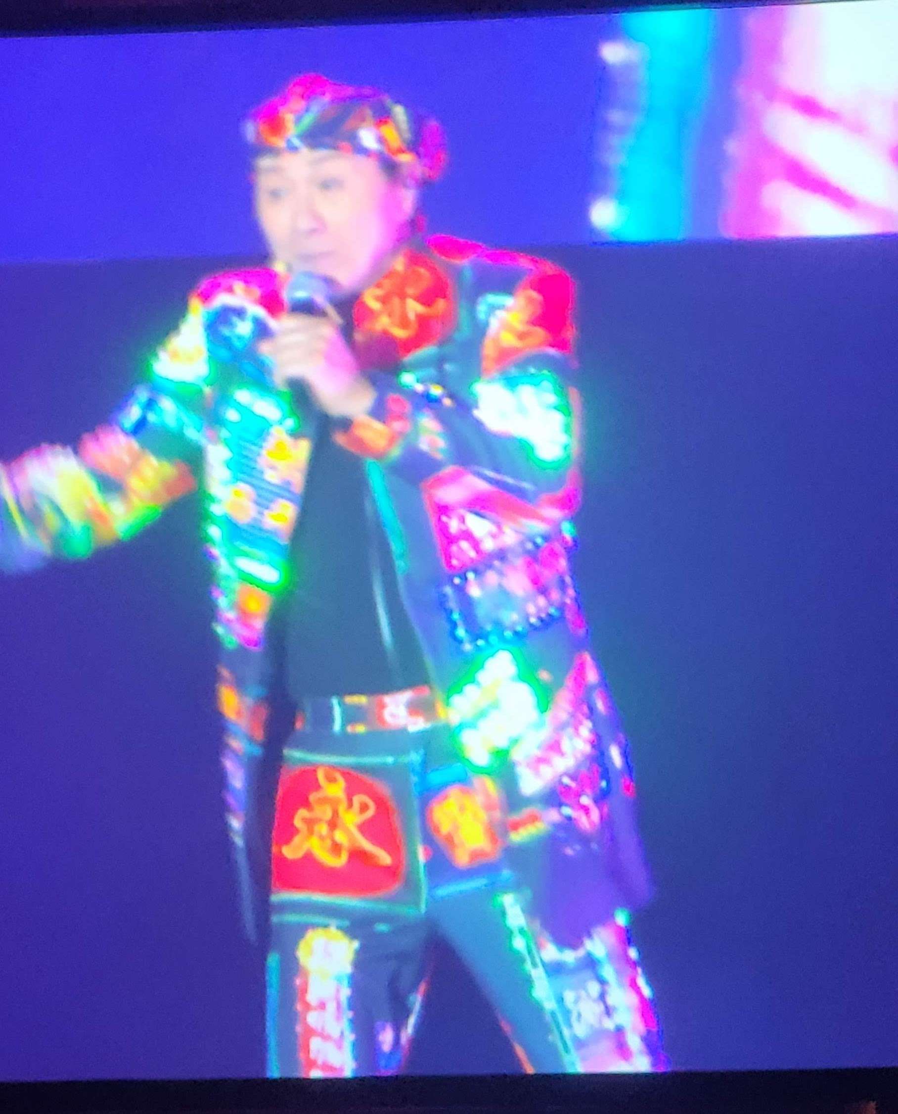 sam hui, in a glowing neon sign suit